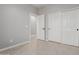 Bright bedroom features neutral walls, tile flooring and access to an ensuite bathroom and closet at 10261 W Foothill Dr, Peoria, AZ 85383