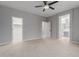 Spacious bedroom featuring a ceiling fan, and entrances to the bathroom and walk-in closet at 10261 W Foothill Dr, Peoria, AZ 85383