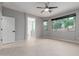 Bright bedroom featuring a ceiling fan and large windows overlooking the outdoor landscape at 10261 W Foothill Dr, Peoria, AZ 85383