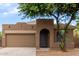 Inviting front exterior showcasing a unique architectural design with an arched entryway at 10261 W Foothill Dr, Peoria, AZ 85383