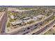 An aerial view showcasing a gas station, retail stores, and a busy highway, highlighting the commercial area and accessibility at 10261 W Foothill Dr, Peoria, AZ 85383