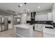 Modern kitchen with white cabinets, stainless steel appliances, and a large island at 10261 W Foothill Dr, Peoria, AZ 85383