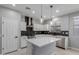 Bright kitchen with quartz countertops, pendant lights, and stainless steel appliances at 10261 W Foothill Dr, Peoria, AZ 85383