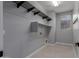 Spacious laundry room features hanging racks, shelving and includes washer and dryer hookups at 10261 W Foothill Dr, Peoria, AZ 85383