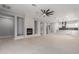 Open-concept living room with sleek fireplace and modern ceiling fan at 10261 W Foothill Dr, Peoria, AZ 85383