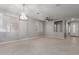 Spacious living area with tile flooring, modern light fixtures, and neutral paint at 10261 W Foothill Dr, Peoria, AZ 85383