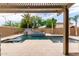 Luxury pool with lush landscaping, water features, and travertine tile creates a serene backyard oasis at 10261 W Foothill Dr, Peoria, AZ 85383