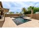 A luxury pool is surrounded by lush landscaping, water features and travertine tile which creates a backyard oasis at 10261 W Foothill Dr, Peoria, AZ 85383
