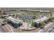 Aerial view showing a shopping center with tree-lined parking, various retail shops, and roads, showcasing the commercial hub at 10261 W Foothill Dr, Peoria, AZ 85383