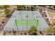 Aerial view of four fenced tennis courts with fresh gray and green surfacing at 10261 W Foothill Dr, Peoria, AZ 85383