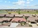 Expansive aerial view of a well-maintained home with desert landscaping and community golf course in background at 11320 E Newcastle Ave, Mesa, AZ 85209