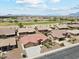 Stunning aerial view of a community featuring well-maintained homes, a golf course, and mountain views at 11320 E Newcastle Ave, Mesa, AZ 85209