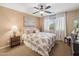 Inviting bedroom featuring a ceiling fan, a large bed, and soft neutral colors, promoting relaxation at 11320 E Newcastle Ave, Mesa, AZ 85209