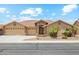 Charming single-story house has desert landscaping, a three-car garage, and a tile roof at 11320 E Newcastle Ave, Mesa, AZ 85209