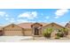 Charming home with a three-car garage, stone accents, and desert landscaping in a well-kept neighborhood at 11320 E Newcastle Ave, Mesa, AZ 85209