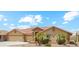 Beautiful exterior of a well-maintained home featuring a three-car garage and mature desert landscaping at 11320 E Newcastle Ave, Mesa, AZ 85209