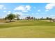 Beautiful Sunland Springs golf course features a lush green fairway and a red flag marking the pin at 11320 E Newcastle Ave, Mesa, AZ 85209