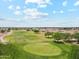 Aerial view of green golf course surrounded by single story homes and trees at 11320 E Newcastle Ave, Mesa, AZ 85209