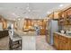 Modern kitchen featuring stainless steel appliances, granite countertops, wooden cabinets, and a ceiling fan at 11320 E Newcastle Ave, Mesa, AZ 85209