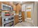 Kitchen featuring stainless steel appliances, including double oven, and wooden cabinets with granite countertop at 11320 E Newcastle Ave, Mesa, AZ 85209