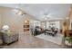 Bright and airy living room showcasing tile flooring, ceiling fans, and seamless flow to the dining area at 11320 E Newcastle Ave, Mesa, AZ 85209