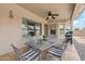 Relaxing covered patio, perfect for dining al fresco with stylish chairs and a ceiling fan at 11320 E Newcastle Ave, Mesa, AZ 85209