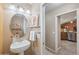 Charming powder room featuring a pedestal sink, decorative mirror and sconce lighting at 11320 E Newcastle Ave, Mesa, AZ 85209