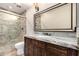 Bathroom featuring a glass enclosed shower, decorative mirror, granite counters and tile floors at 14058 S 24Th Way, Phoenix, AZ 85048