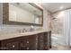 This bathroom features dual sinks, a bathtub and shower combination, and tile floors at 14058 S 24Th Way, Phoenix, AZ 85048