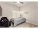 The bedroom features neutral walls, tile floors, a window providing natural light and a ceiling fan at 14058 S 24Th Way, Phoenix, AZ 85048