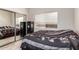 This bedroom features neutral walls, tile floors, a window providing natural light, and mirrored closet doors at 14058 S 24Th Way, Phoenix, AZ 85048