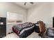 Cozy bedroom with neutral walls, tile floors, ceiling fan and a window providing natural light at 14058 S 24Th Way, Phoenix, AZ 85048