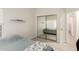A view of the bedroom showing the neutral walls, tile floors, a window and mirrored closet doors at 14058 S 24Th Way, Phoenix, AZ 85048
