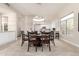Bright dining space with a round table, modern lighting, and a view of the kitchen at 14058 S 24Th Way, Phoenix, AZ 85048