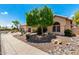 Lovely home exterior with rock landscaping and mature shade tree in front at 14058 S 24Th Way, Phoenix, AZ 85048