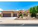 Charming single-story home showcasing a two-car garage, desert landscaping, and a tile roof at 14058 S 24Th Way, Phoenix, AZ 85048