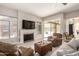 Cozy living room with a fireplace, entertainment center, and comfortable seating, great for gatherings at 14058 S 24Th Way, Phoenix, AZ 85048