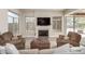 Inviting living room with fireplace, comfortable leather chairs, and views of the outdoor landscape at 14058 S 24Th Way, Phoenix, AZ 85048