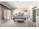 Spacious main bedroom with large windows, neutral tones, and an upholstered bench seat at 14058 S 24Th Way, Phoenix, AZ 85048