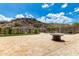 Expansive outdoor patio with built in fire pit, mountain views and black wrought iron perimeter fence at 14058 S 24Th Way, Phoenix, AZ 85048