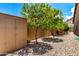 Storage shed, desert foliage, and stone ground cover in an enclosed backyard at 14058 S 24Th Way, Phoenix, AZ 85048