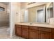 Bathroom featuring a sink, vanity, cabinets, large mirror, and shower at 14494 W Yucatan St, Surprise, AZ 85379