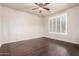An unfurnished bedroom with dark wood floors, neutral walls, and large windows with plantation shutters at 14494 W Yucatan St, Surprise, AZ 85379