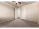 Bedroom with neutral walls and carpet, ceiling fan, and multiple entry doors at 14494 W Yucatan St, Surprise, AZ 85379
