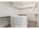 Walk-in closet featuring custom shelving, drawers, and ample storage space at 14494 W Yucatan St, Surprise, AZ 85379