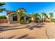 Beautiful home featuring desert landscaping, a brick driveway, and mature palm trees at 14494 W Yucatan St, Surprise, AZ 85379