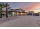 Spacious home featuring a three-car garage, desert landscaping, and a private gate at 14494 W Yucatan St, Surprise, AZ 85379