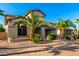 Beautiful home featuring desert landscaping, a brick driveway, and mature palm trees at 14494 W Yucatan St, Surprise, AZ 85379