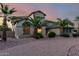 Beautiful home featuring desert landscaping, a circular brick driveway, and mature palm trees at 14494 W Yucatan St, Surprise, AZ 85379