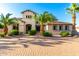 Charming home featuring desert landscaping, a brick driveway, and mature palm trees at 14494 W Yucatan St, Surprise, AZ 85379
